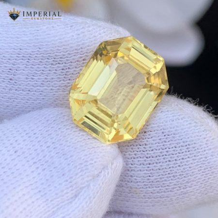 Premium certified natural Ceylon Yellow Sapphire 7.61 carat emerald cut loose gemstone for custom engagement ring or pendant jewelry.