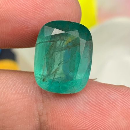 Premium certified Zambia emerald 13.49 carats featuring a vibrant green color, precision cushion cut, and dimensions of 16.07 x 12.65 x 8.88 mm.