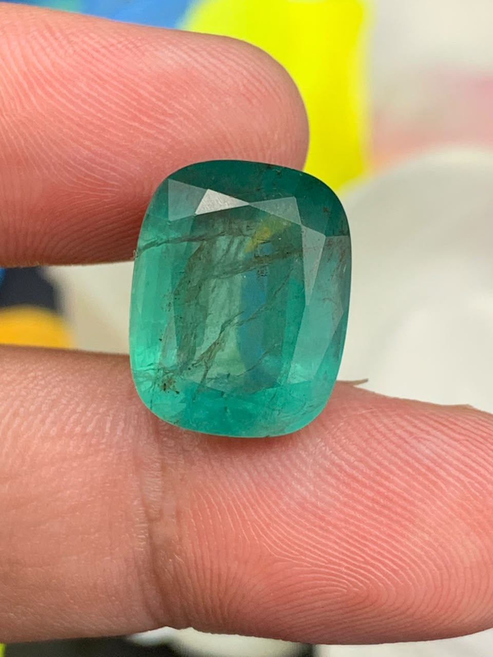 certified-natural-emerald-13.49-carats-imperialgemstone Premium certified Zambia emerald 13.49 carats featuring a vibrant green color, precision cushion cut, and dimensions of 16.07 x 12.65 x 8.88 mm.